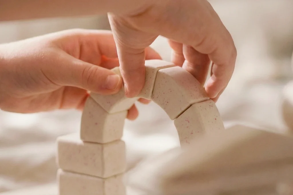Child building an arch structure with Arch-Kid-Tech architectural building system