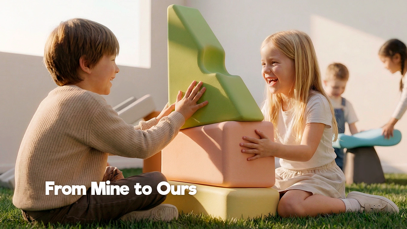 Children working together to place large play blocks, showing cooperative play and shared decision-making.